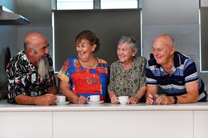 Four senior people having a drink together