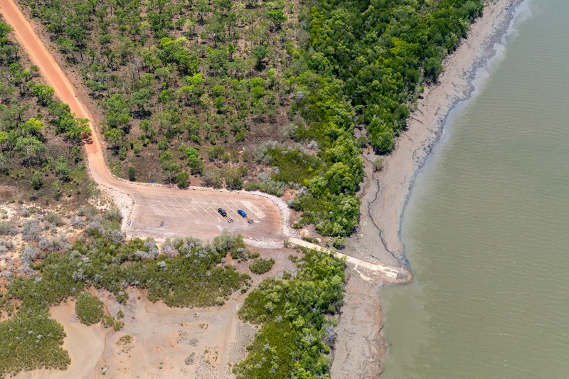 Aerial photograph of Middle Arm boat ramp and rock bar on 18 October 2024, when Darwin Harbour's low tide.